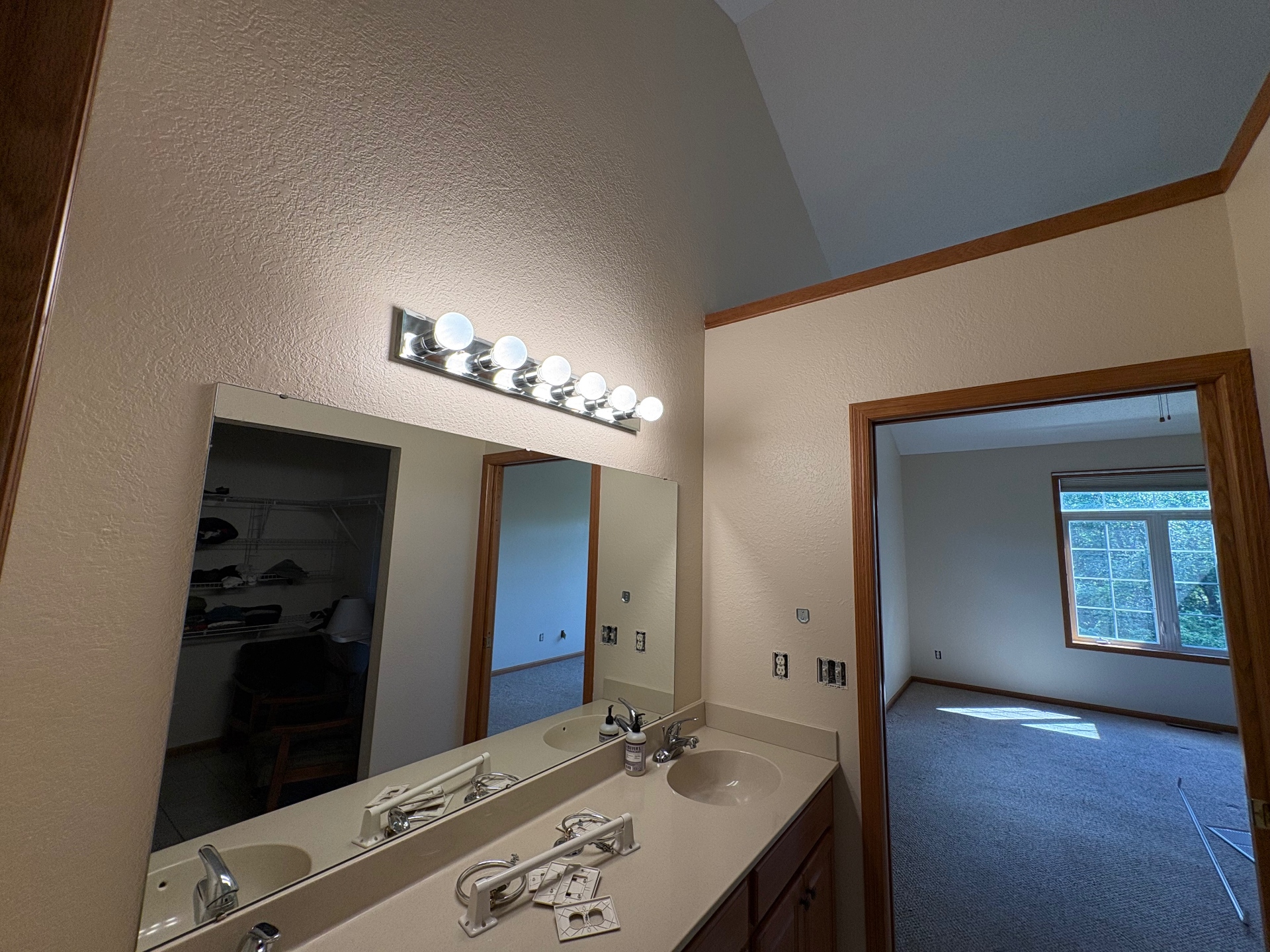 Double Vanity Bathroom — Warm, even coverage tying the bath into the adjoining bedroom.