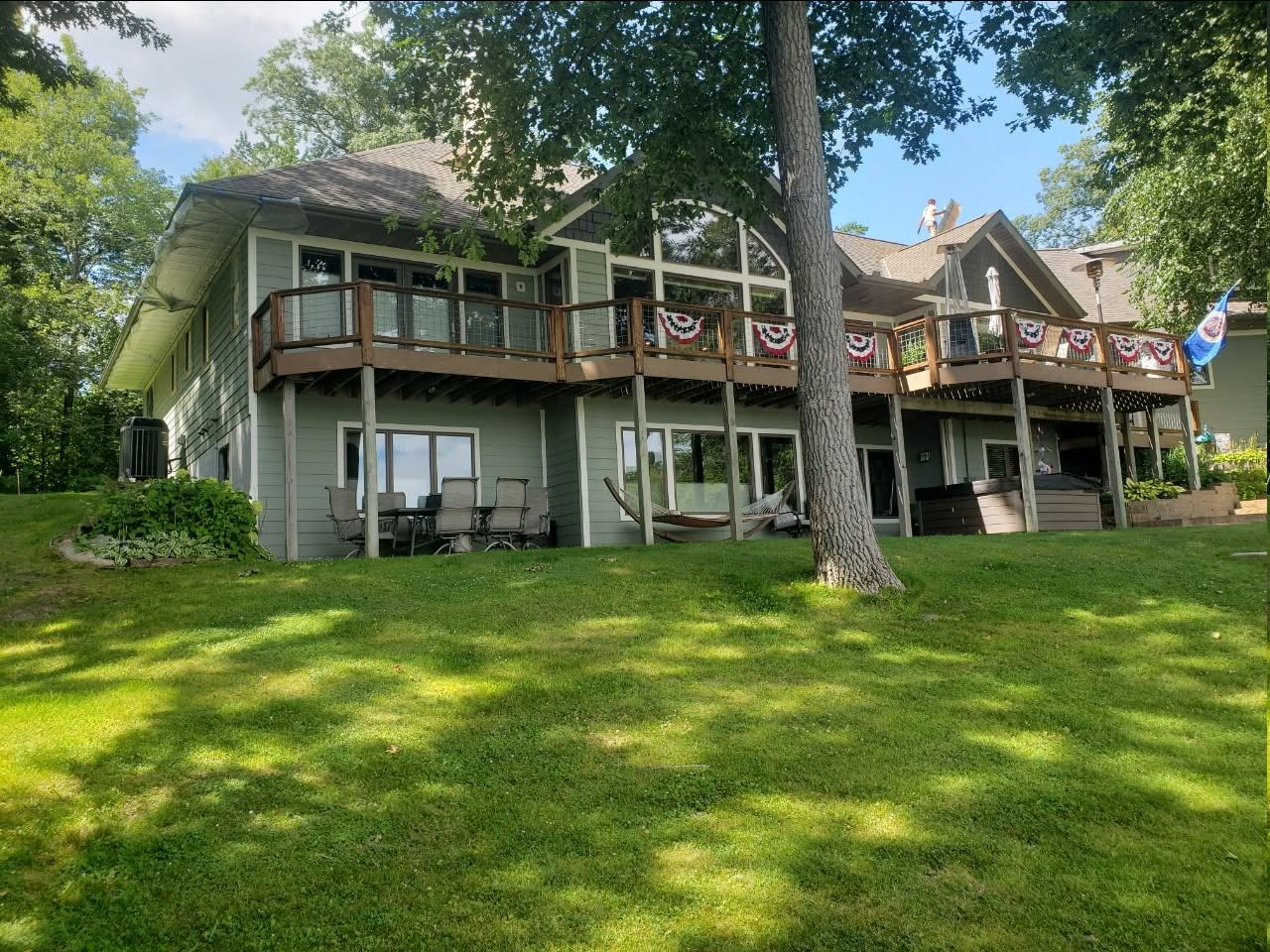 Two-story lake home with fresh exterior paint and stained decks