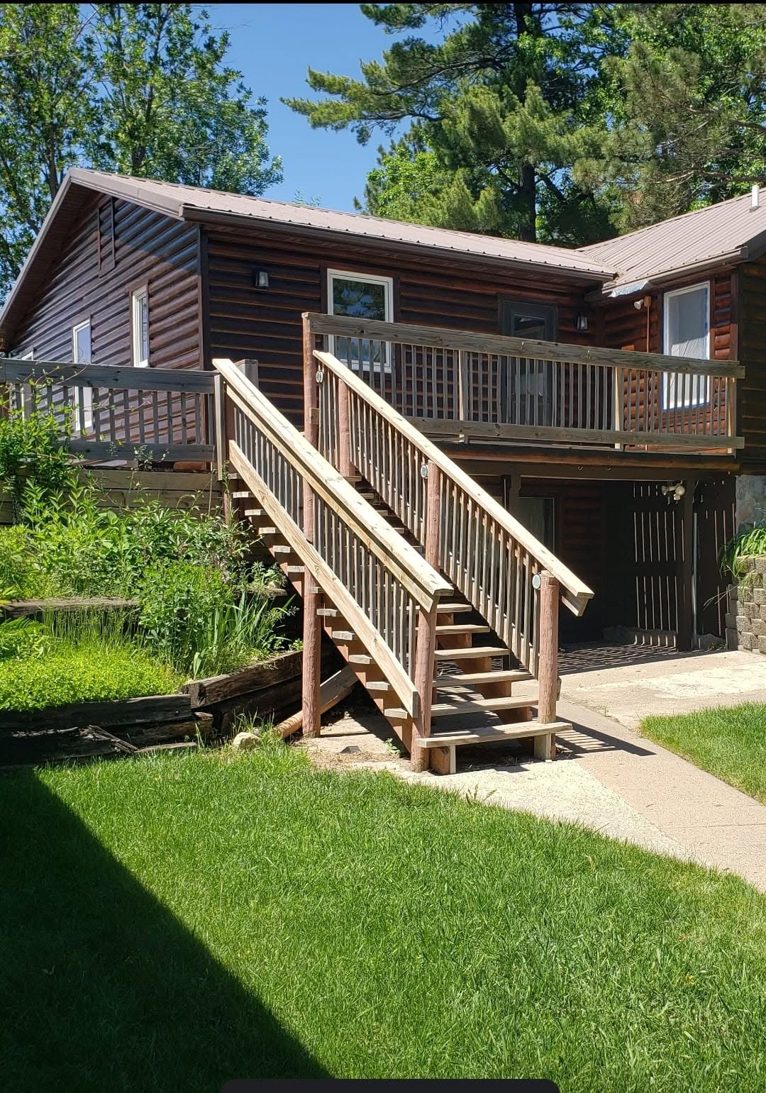 Log Home & Deck — Deep-toned log home staining with fresh deck work.
